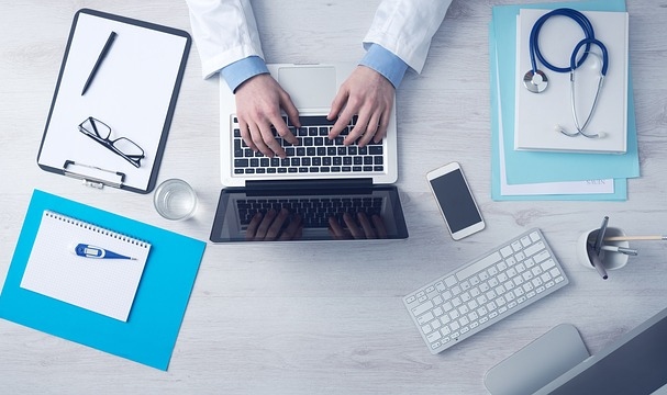 Enrolling in Medicare Doctor Using Laptop