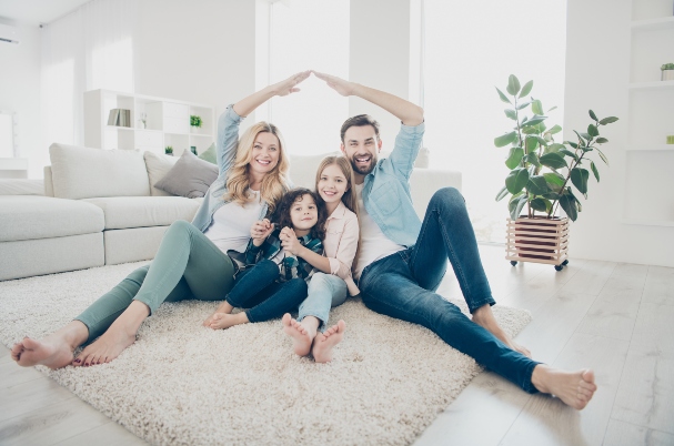 Should you pay off your mortgage early depicts parents using their arms to create a house over their children.