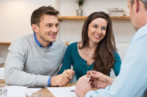 Get started on your financial planning page depicts a young couple meeting financial advisor for investment