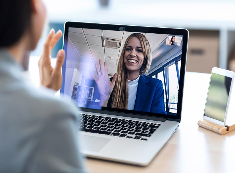 Female employee having a video call on a laptop with another female employee.