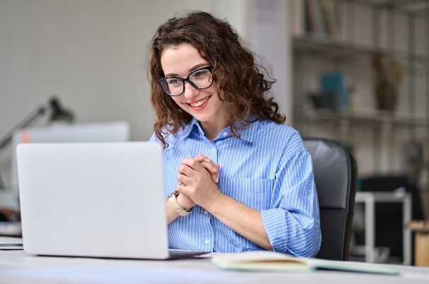 Woman researching on computer to improve salary negotiation skills.