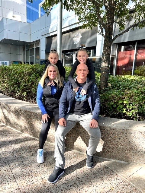 Patrick Beale and family in front of gym.