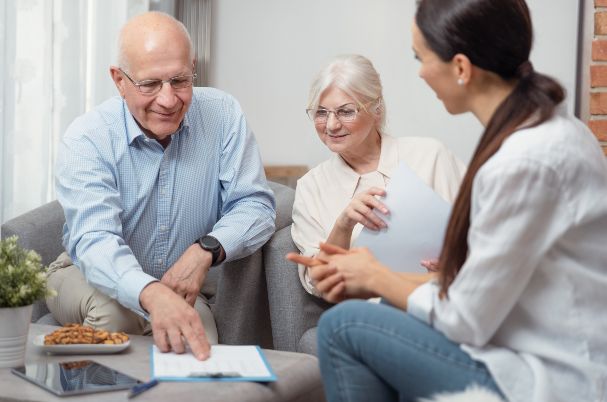 Family member sitting with elderly parents with a list of questions to ask parents about estate planning.