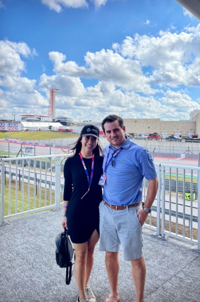 Tom Kennedy and wife standing in front of airport.