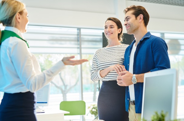 Navigating joint or separate bank accounts with a positive excited young couple.