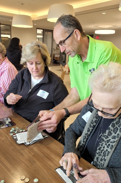 Jeff LeGrow works with volunteers at Nickel from Nicole annual event.