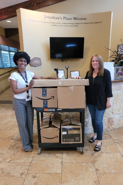 Pamela Engstrom delivers summer camp supplies to Ashley at Jonathan's Place